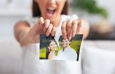 Divorce. Angry Woman Ripping Wedding Photo With Ex-Husband After Breakup Indoor. Selective Focus