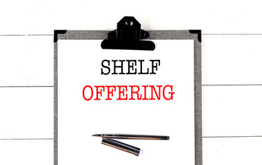 SHELF OFFERING text on clipboard on white background