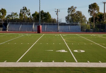 empty football field and bleachers
