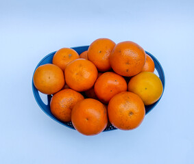 oranges in a bowl on white background 