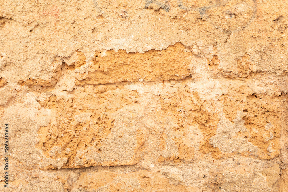 Poster a weathered brick wall with patches of missing mortar