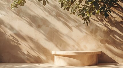 A beige natural podium pedestal against a textured wall with soft sunlight filtering through tree branches, creating a serene and organic atmosphere.