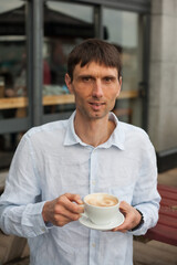 joyful cheerful middle-aged man in nature on a warm sunny day