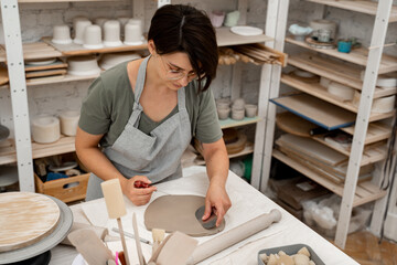 Wedging the clay to eliminate air bubbles. Creating perfect homogenous consistence for ceramics...