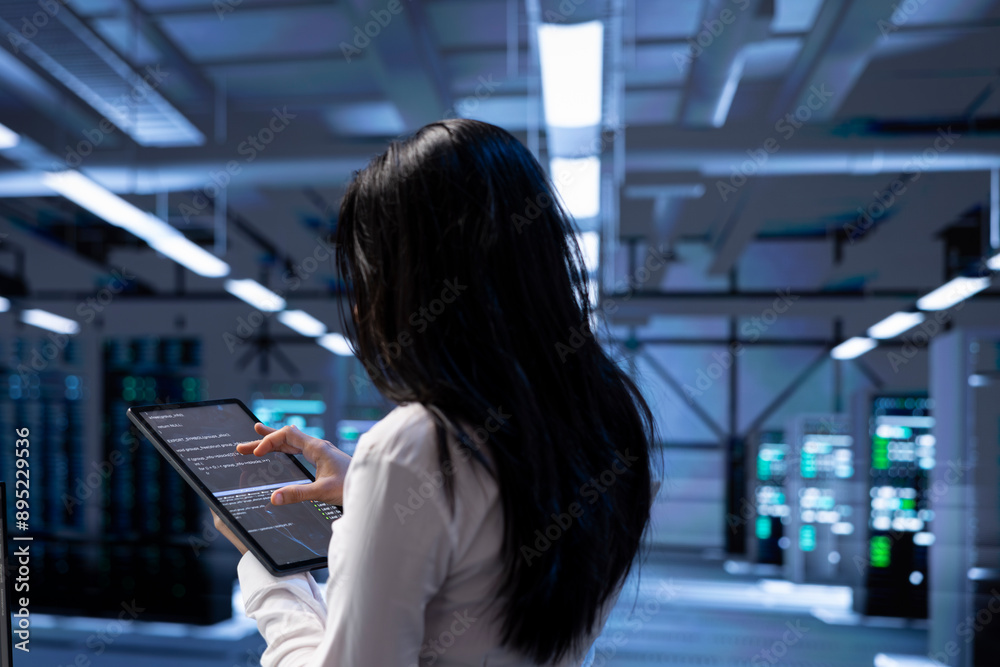 Poster admin in data center using tablet to check for server performance issues arising due to high cpu usa