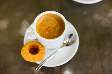 Cup of fresh cortado, Spanish beverage made of espresso with dessert