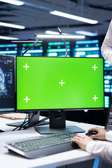Close up of computer scientist monitoring server hub using AI software on green screen PC....