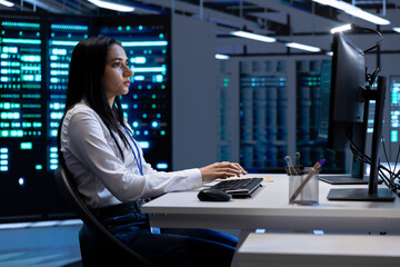Engineer in data center checking equipment performance on PC after installing and upgrading...