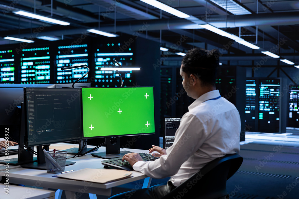 Poster admin in data center using diagnostic tools and system monitoring software on green screen pc to ide