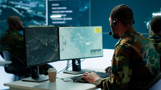Army intelligence specialist utilize advanced computer systems, surveillance technology and data to enhance national security. Working in a command post against potential threats. Camera A.