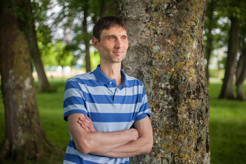 joyful cheerful middle-aged man in nature on a warm sunny day