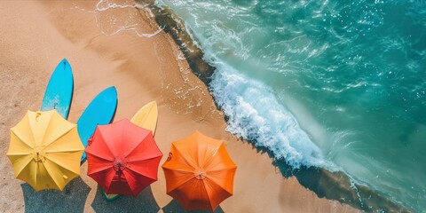 Obraz premium Top view, holiday mood with colorful umbrellas surfboards.