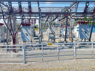high-voltage transformer of high electrical power at a substation against the blue sky.