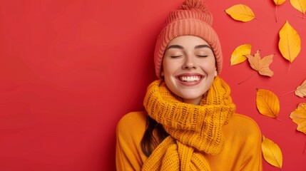 beautiful woman smiling at the camera and wrapped in autumn colors with yellow leaves on red background