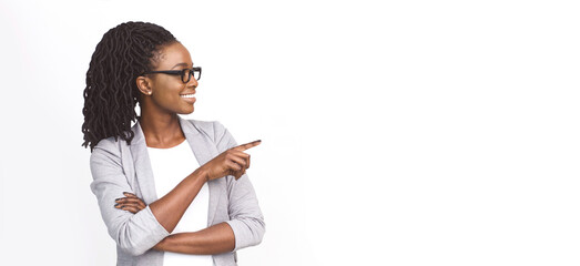 Millennial African American businesswoman pointing at copy space for advertisement over white...
