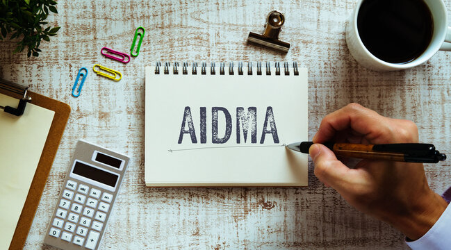 There is notebook with the word AIDMA. It is as an eye-catching image.