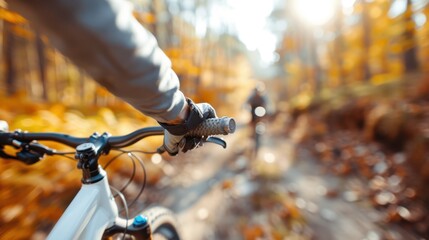 A close-up shot capturing a person’s gloved hand on the bike handlebar as they navigate through a colorful autumn forest trail, evoking adventure and nature’s beauty.