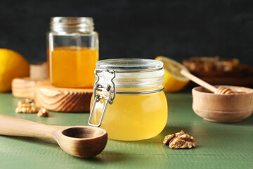 Jars of sweet honey on table