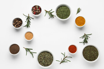 Frame made of bowls with spices and rosemary on light background