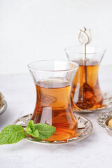 Glasses of Turkish tea on white background