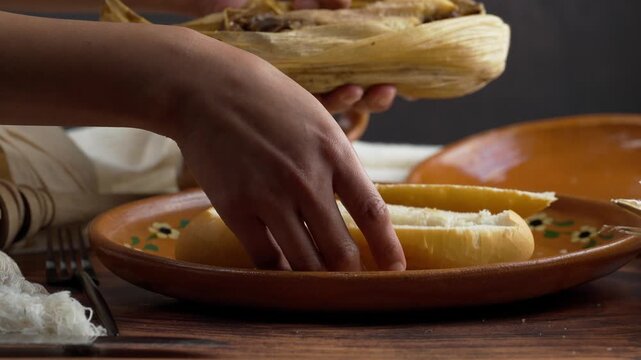Torta de tamal, Latin woman takes a mole poblano tamale to place it on a bolillo and prepare a Mexican guajolota, Food from Mexico city