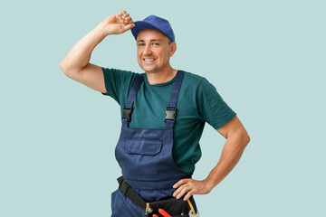 Portrait of male mechanic on blue background