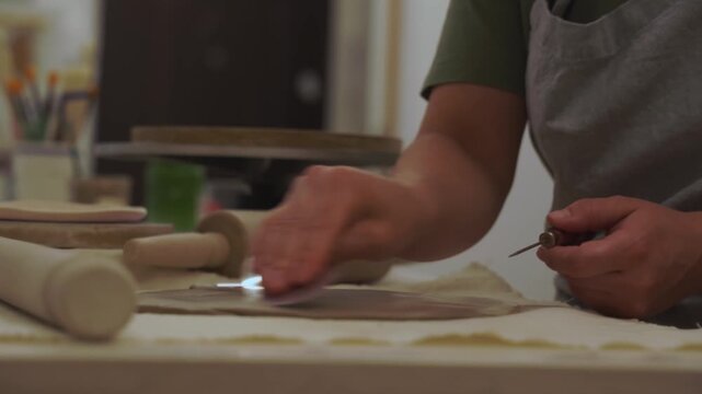 Removing air bubbles from clay before hand building 4k video. Preventing clay bodies from cracks by wedging. Making pliable clay without air pockets.