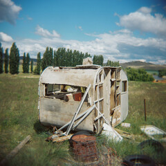 Abandoned caravan falling to pieces in a rural paddock