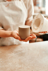 Hands, mold and pottery clay in studio for ceramics, shape and craft into pattern with detail. Woman, bowl and sculpting hobby for potter in workplace for creative art, process and handmade design