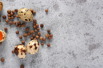 Raw quail eggs and allspice on grunge background
