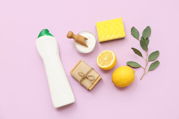 Composition with natural cleaning supplies and eucalyptus branch on lilac background