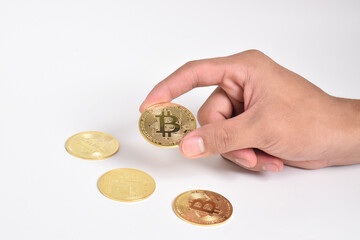 Man's hand holding bitcoin isolated on white background. Copy space. Crypto currency concept. Savings, investments concept. Modern digital method of payment. Clipping path