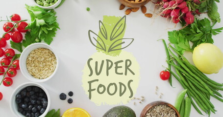 Super foods text image over various healthy ingredients on white background