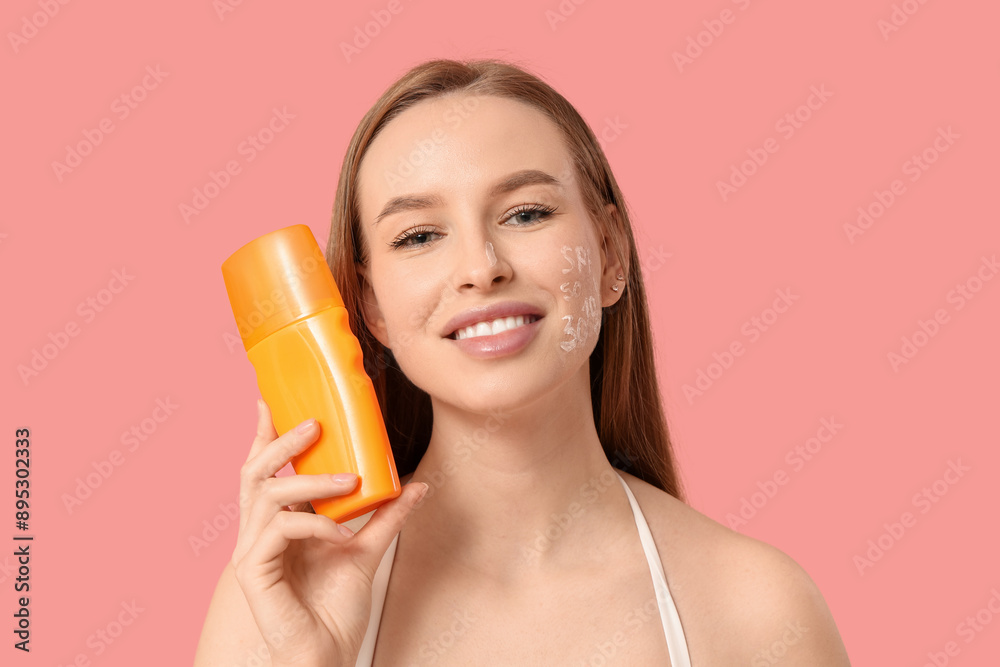 Sticker beautiful young happy woman with bottle of sunscreen cream on pink background