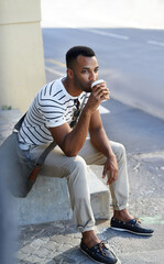Thinking, coffee and man with relax outdoor for street culture, designer or creative internship and city environment. Male person, idea and morning for commute or travel in Los Angeles on sidewalk.