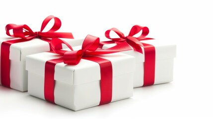 Fototapeta premium Three white boxes with red bows on top of them