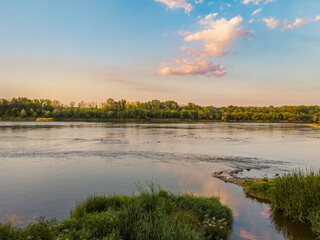 Outlet of the Bielany storm collector to the Vistula River at sunset in summer in Warsaw, Poland