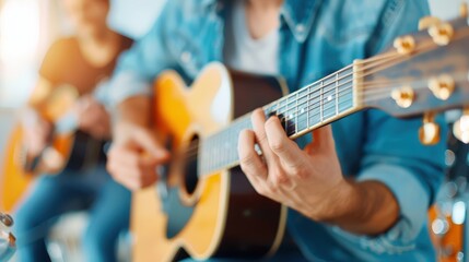 Obraz premium This image captures a close-up view of a man passionately playing an acoustic guitar, representing the dedication and emotions involved in musical performance on stage.