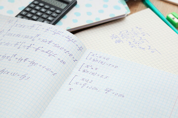 Obraz premium Copybooks with math formulas and stationery, closeup
