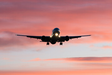 airplane landing at sunrise, golden hour, airport traffic, aviation industry