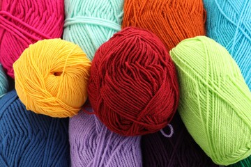 Many beautiful bright yarns as background, above view