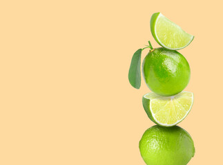 Stacked fresh limes on beige background, space for text