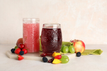 Glasses of fresh juice with different fruits on white background