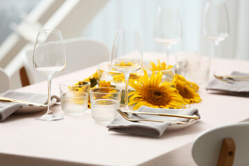 Table setting with beautiful sunflowers. Closeup