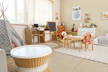 Interior of children's room with tables, shelves and toys