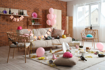 Interior of messy living room after Birthday celebration with sofa, armchairs and party decor