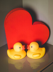 Two Yellow Rubber Ducks With Red Heart Background
