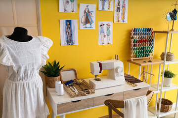 Interior of atelier with tailor's workplace, mannequin and sketches