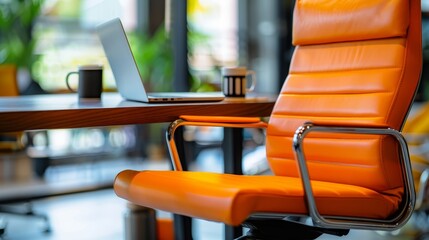 A modern office workspace featuring a comfortable orange leather chair, a laptop, and a wooden desk. The chair represents productivity, the laptop symbolizes technology, the desk signifies professiona