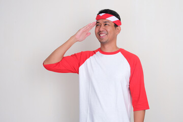 Indonesian man smiling while doing salute